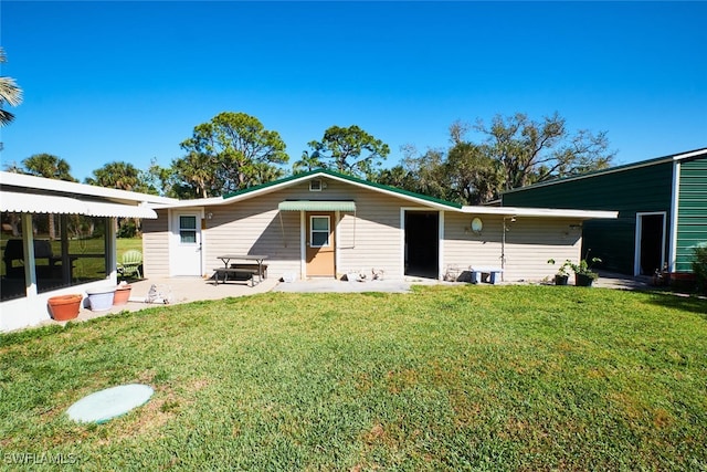 rear view of house with a patio area and a yard