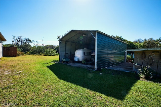 view of outbuilding featuring a detached carport and driveway