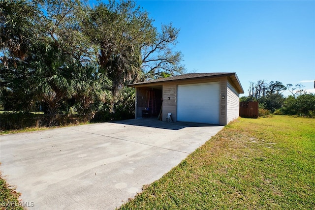 garage featuring concrete driveway