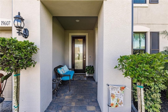 view of exterior entry with stucco siding