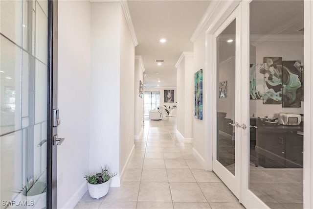 corridor with light tile patterned floors, recessed lighting, baseboards, french doors, and ornamental molding