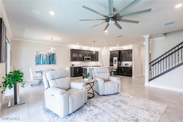 living room with crown molding, light tile patterned floors, recessed lighting, visible vents, and stairway