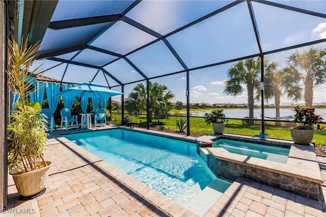 view of swimming pool featuring a patio area, a lanai, and a pool with connected hot tub