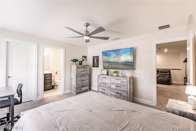 carpeted bedroom with baseboards, visible vents, ceiling fan, and connected bathroom