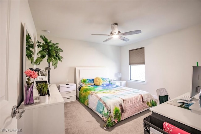 bedroom with a ceiling fan and light colored carpet