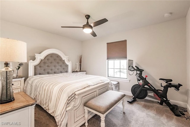 bedroom featuring a ceiling fan, dark colored carpet, and baseboards