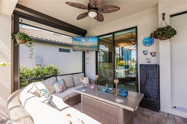 view of patio with an outdoor living space and a ceiling fan