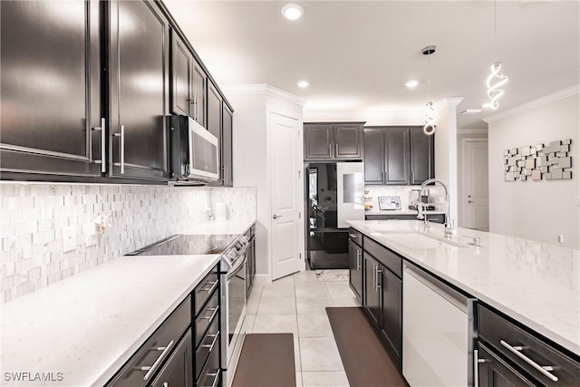 kitchen featuring light tile patterned floors, decorative backsplash, stainless steel appliances, crown molding, and a sink