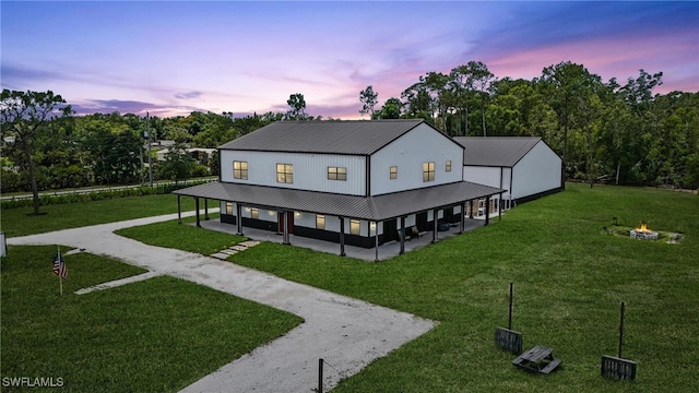 1474 Saint Clair Shores Rd, Naples, FL 34104 - rear view of property with a fire pit, a yard, driveway, and a patio