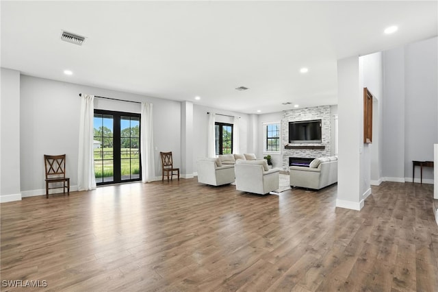 1474 Saint Clair Shores Rd, Naples, FL 34104 - living area featuring wood finished floors, a stone fireplace, and recessed lighting