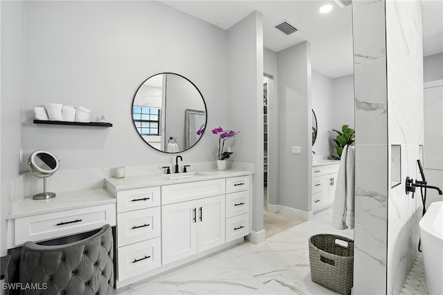 1474 Saint Clair Shores Rd, Naples, FL 34104 - full bathroom with marble look tiles, vanity, and a soaking tub
