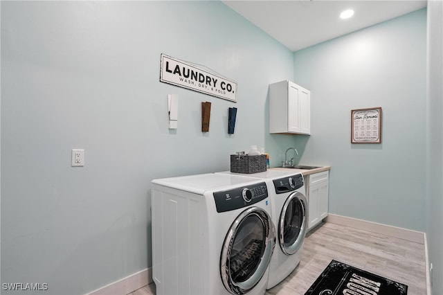 1474 Saint Clair Shores Rd, Naples, FL 34104 - washroom with washing machine and dryer, cabinet space, light wood finished floors, and recessed lighting