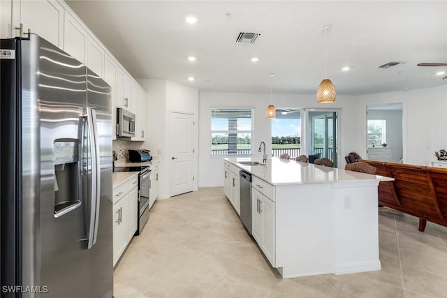 kitchen with appliances with stainless steel finishes, visible vents, a sink, and white cabinetry