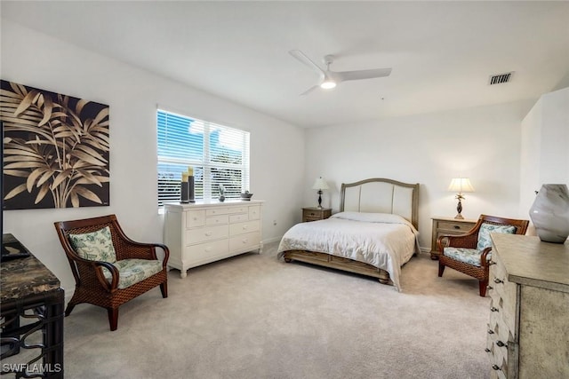 bedroom featuring light colored carpet, visible vents, ceiling fan, and baseboards