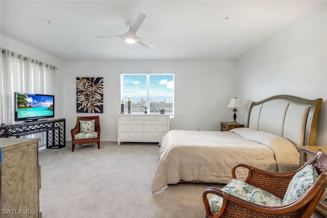 bedroom featuring baseboards, a ceiling fan, and light colored carpet