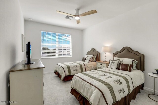 bedroom featuring a ceiling fan, light colored carpet, visible vents, and baseboards