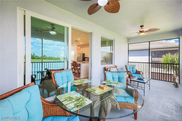 sunroom / solarium with a ceiling fan