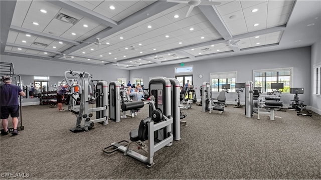 exercise room featuring a high ceiling, recessed lighting, visible vents, and baseboards