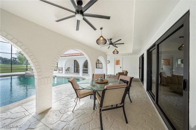 view of patio / terrace featuring a lanai, an outdoor pool, and ceiling fan