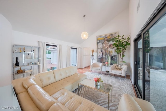 living area with high vaulted ceiling