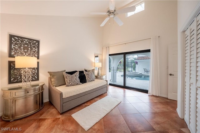 bedroom featuring baseboards, a high ceiling, ceiling fan, tile patterned flooring, and access to exterior