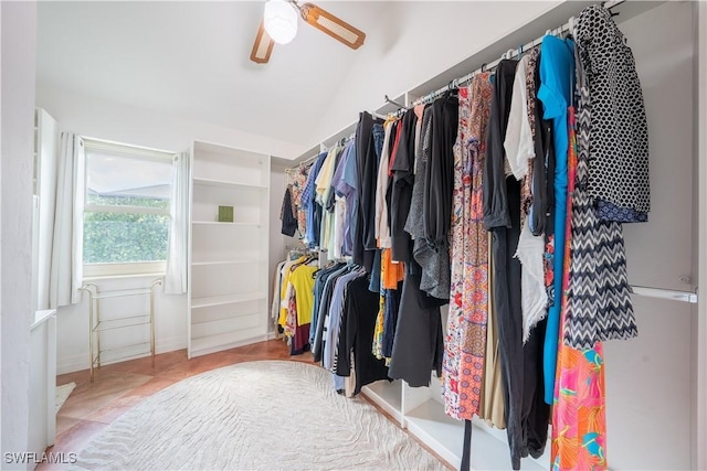 spacious closet with ceiling fan and vaulted ceiling