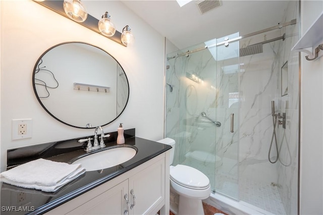 full bath with a marble finish shower, visible vents, toilet, and vanity