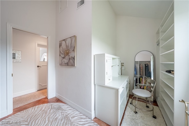 hallway with visible vents and baseboards