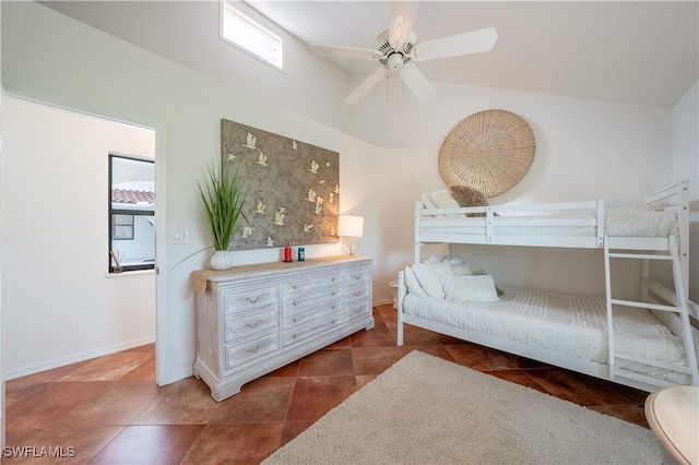 bedroom with tile patterned flooring, a ceiling fan, and baseboards