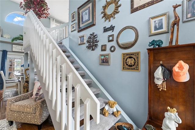 stairs featuring a high ceiling