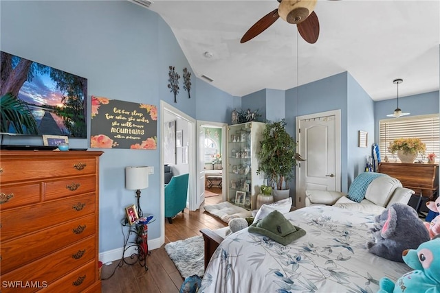 bedroom with visible vents, wood finished floors, baseboards, lofted ceiling, and ceiling fan