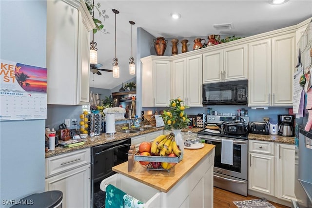 kitchen featuring visible vents, black appliances, a sink, decorative light fixtures, and wooden counters