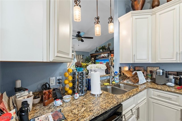 kitchen featuring ceiling fan, dishwasher, light stone counters, white cabinetry, and a sink