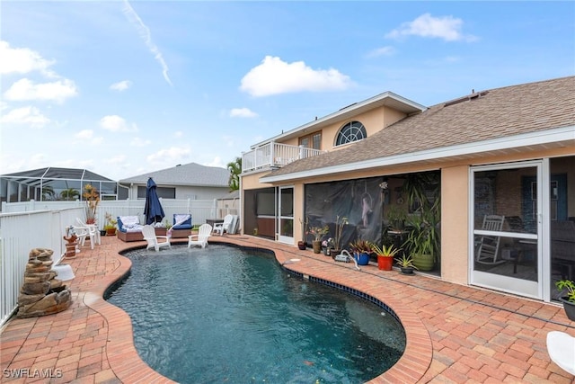 view of swimming pool with a fenced in pool, a patio, a sunroom, and fence