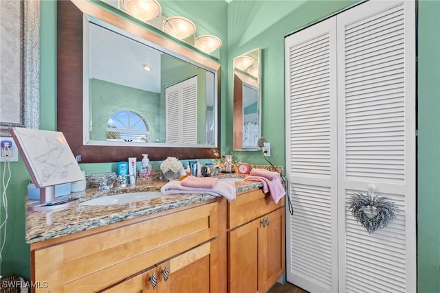 bathroom featuring a closet and vanity