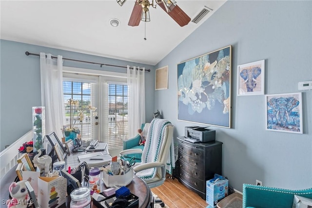 interior space with visible vents, wood finished floors, french doors, ceiling fan, and vaulted ceiling