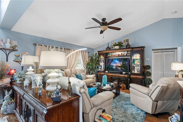 living room featuring a ceiling fan, lofted ceiling, wood finished floors, and visible vents