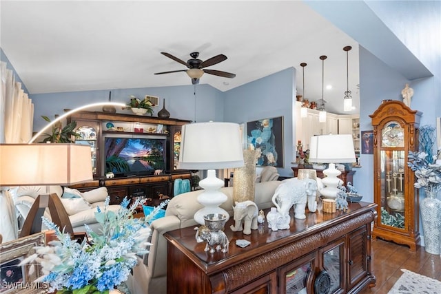 living area featuring vaulted ceiling and a ceiling fan