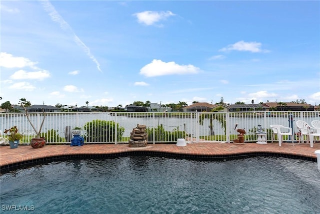 view of swimming pool with fence