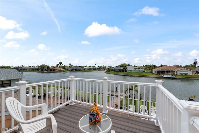 wooden terrace featuring a water view