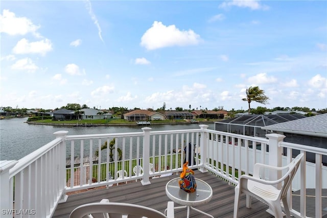 wooden deck featuring a residential view and a water view