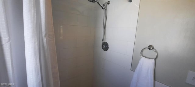 interior details featuring tiled shower