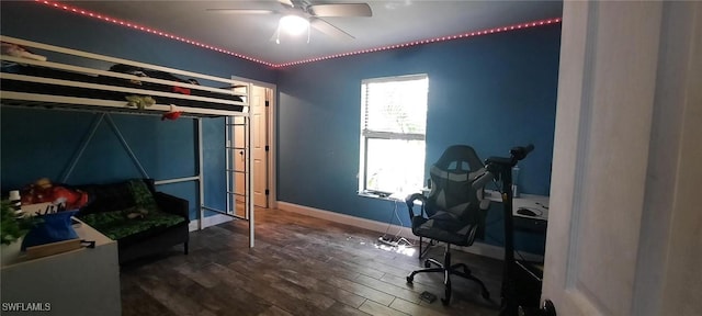 bedroom featuring a ceiling fan, baseboards, and wood finished floors