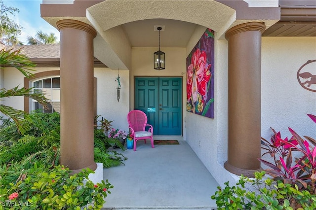 entrance to property featuring stucco siding