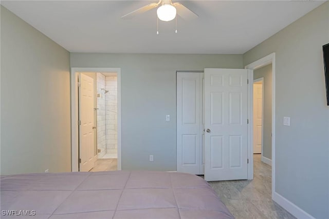 unfurnished bedroom featuring ensuite bath, baseboards, a closet, and ceiling fan