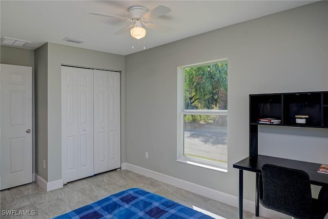 bedroom with a closet, visible vents, multiple windows, and baseboards