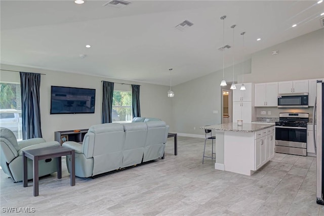 interior space featuring visible vents, appliances with stainless steel finishes, open floor plan, and white cabinetry