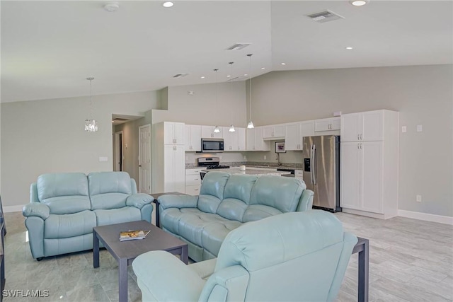 living room with visible vents, recessed lighting, high vaulted ceiling, and baseboards