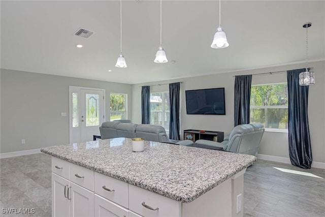 kitchen with visible vents, open floor plan, and a healthy amount of sunlight