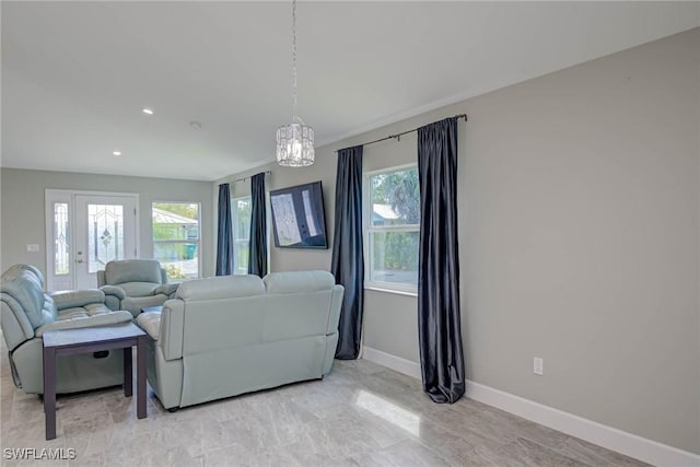 living area featuring recessed lighting and baseboards